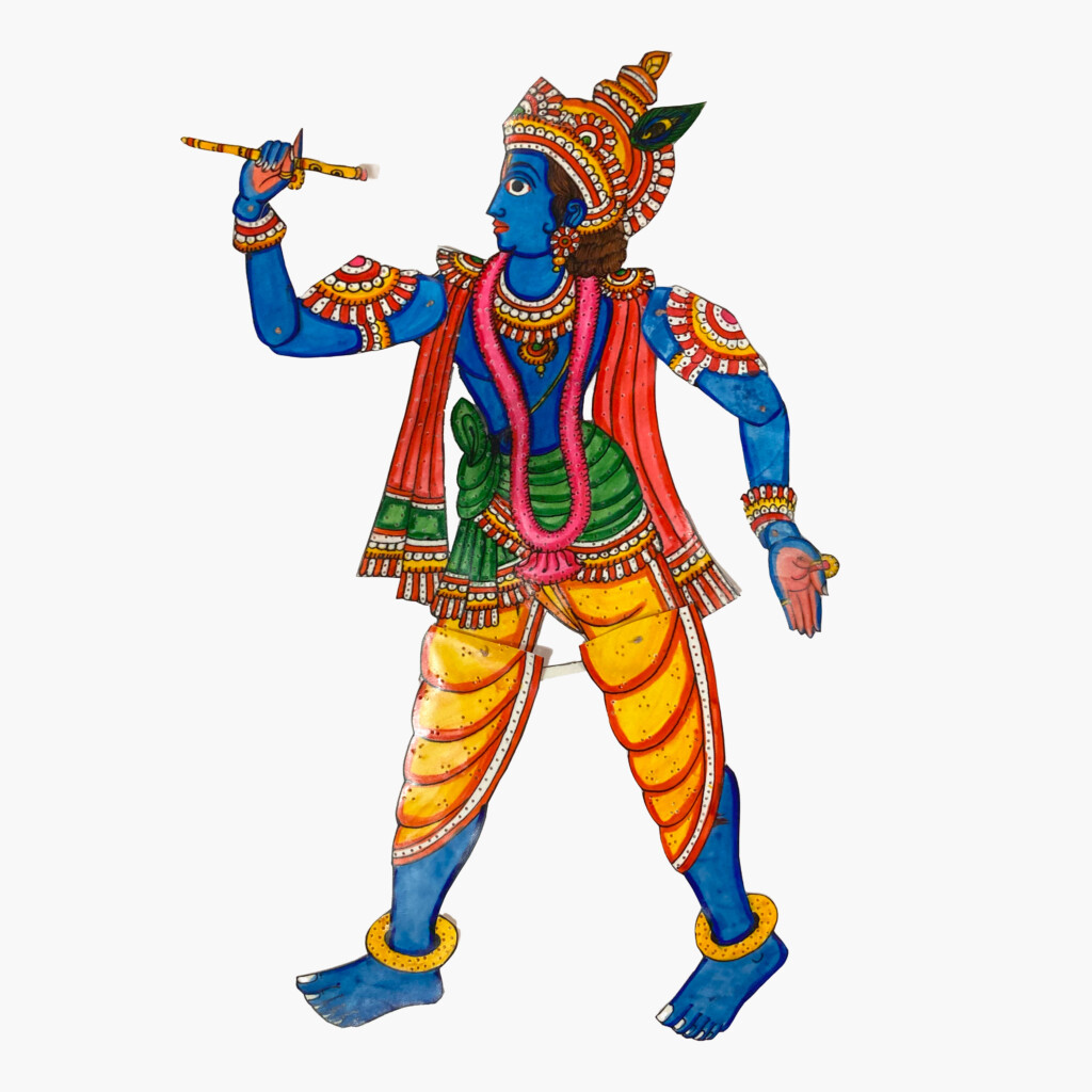 A brightly coloured puppet of Krishna, an avatar of Vishnu. He has blue skin and is wearing colourful clothing and traditional jewellery and is carrying a pipe.
