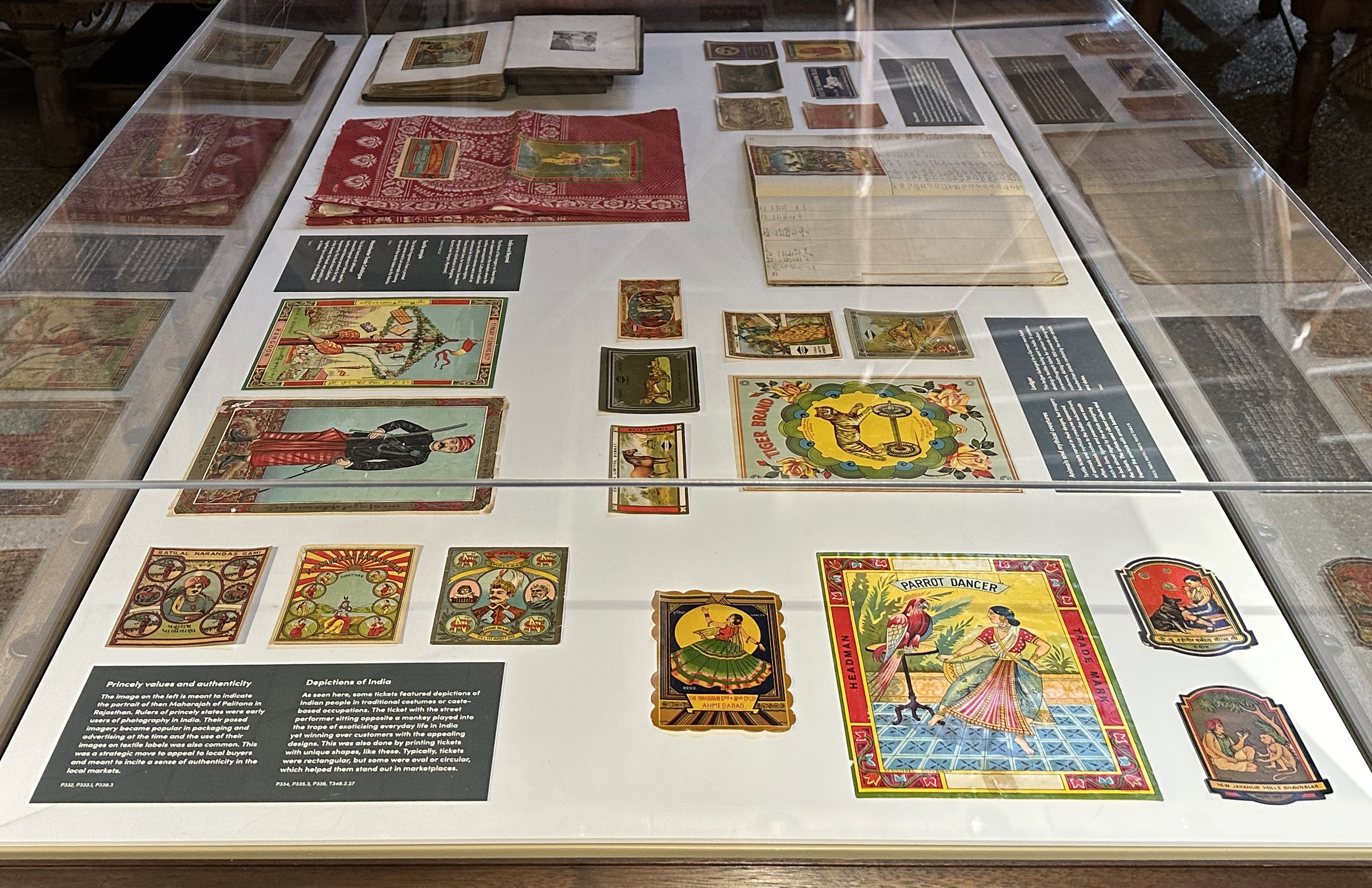 A image from an angle above a cloche displaying lots of textile tickets which are colourful and illustrated