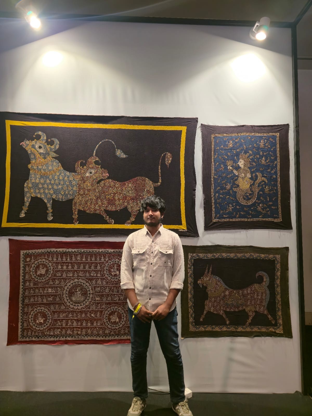 A photo of a mata ni pachedi artist standing in front of his work